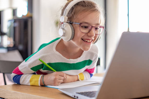 istock Young girl at home listening online class 1283556830