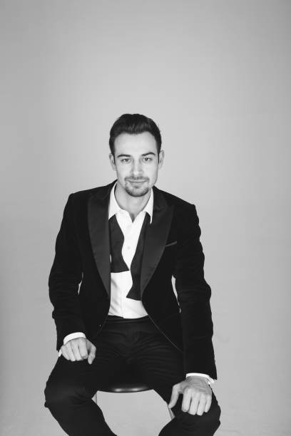 istock Studio portrait of a young man in a tuxedo against plain studio background 1283559043