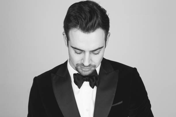 istock Studio portrait of a young man in a tuxedo against plain studio background 1283559051