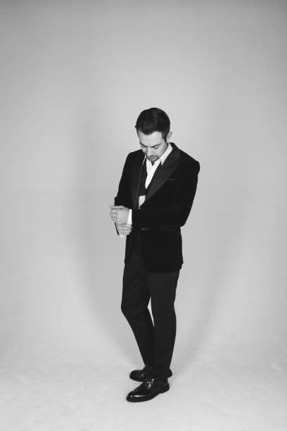istock Studio portrait of a young man in a tuxedo against plain studio background 1283559052