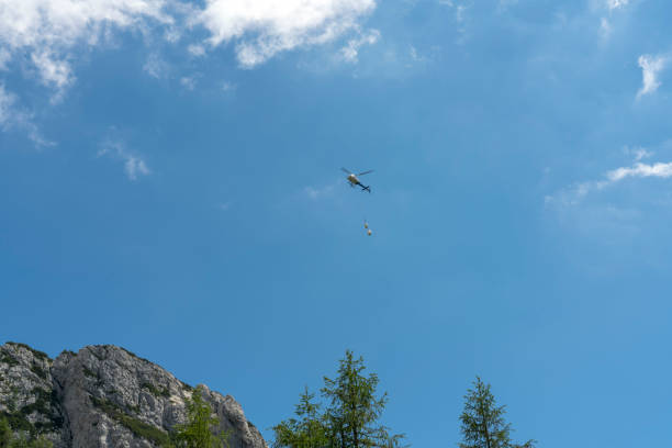 istock Rescue helicopter flying over high mountain 1283559053