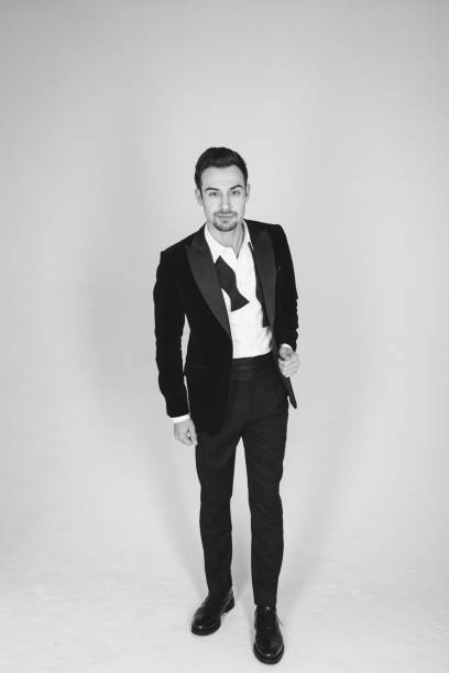 istock Studio portrait of a young man in a tuxedo against plain studio background 1283559056