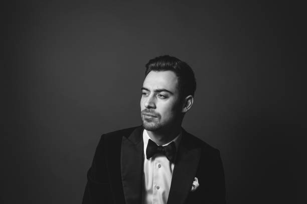 istock Studio portrait of a young man in a tuxedo against plain studio background 1283559059