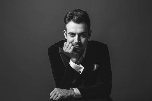 istock Studio portrait of a young man in a tuxedo against plain studio background 1283559079