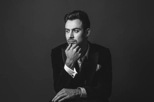 istock Studio portrait of a young man in a tuxedo against plain studio background 1283559369