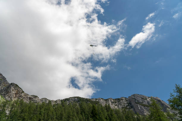 istock Rescue helicopter flying over high mountain 1283559636