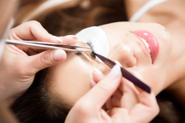 istock Beautician working on upgrading silk eyelashes in a beauty studio. 1283559643