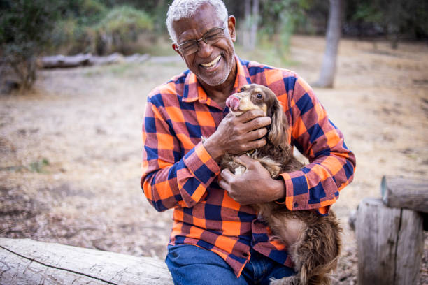 istock Senior Black Man with Long Haired Dachshund 1283560245