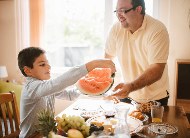 istock Father and son having breakfast at home. 1283560285