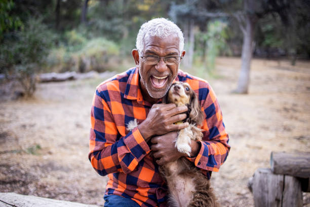 istock Senior Black Man with Long Haired Dachshund 1283561156