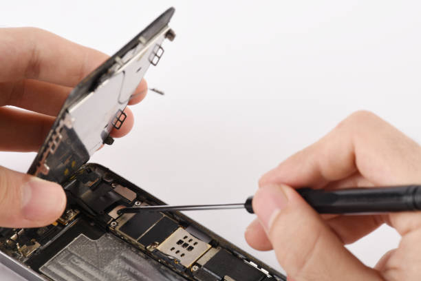 istock Technician repairs the damaged smart mobile phone, serviceman is repairing a damaged smart phone 1283561467