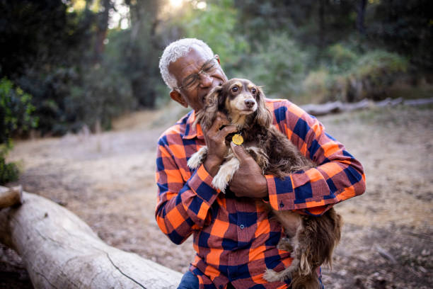 istock Senior Black Man with Long Haired Dachshund 1283561586