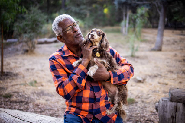 istock Senior Black Man with Long Haired Dachshund 1283561657
