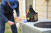 Technician services outside AC units and generator.