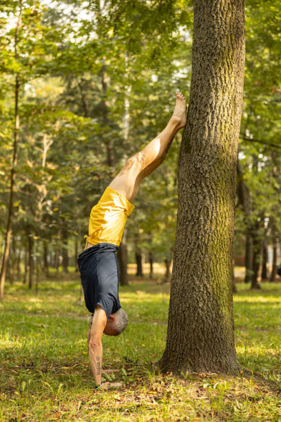 istock Fit male practicing yoga alone in forest 1283563887
