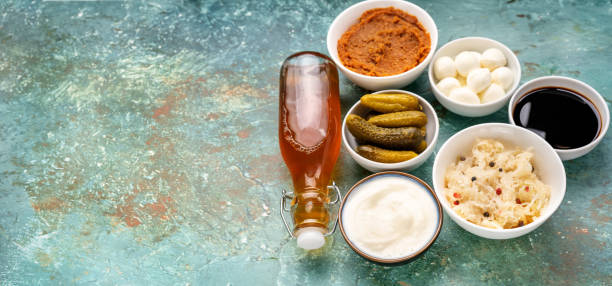many fermented products on light turquoise background - sauerkraut cabbage paprika salad imagens e fotografias de stock