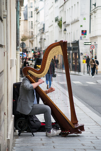 Paris - France - 24 October 2020 - Portrait of musician playing harp in the street