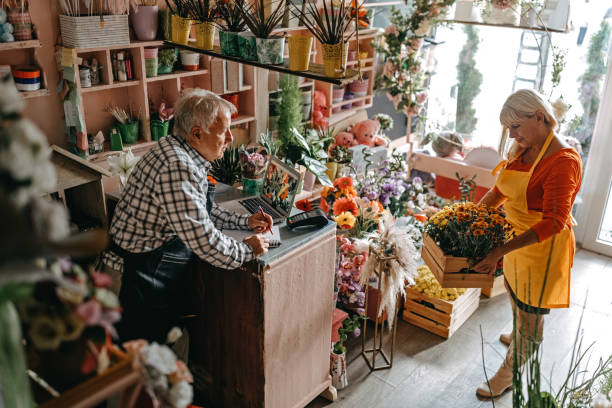 istock Couple Arranging fresh flowers at shop 1283566616