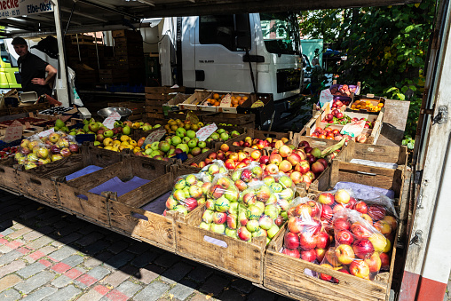 Hamburg, Germany - August 21, 2019: Vendor in a fruit and vegetable shop in Farmer market Großneumarkt, street food market in Neustadt, Hamburg, Germany