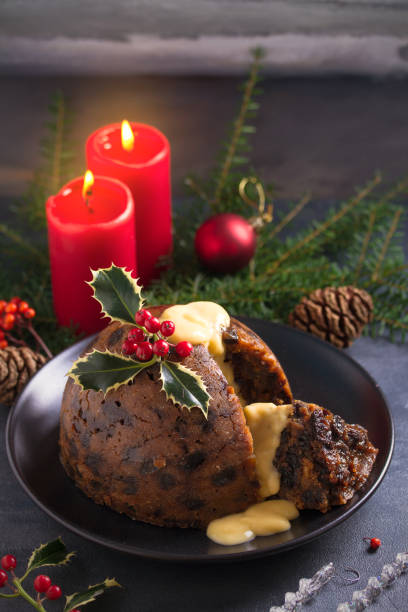istock Richly spiced Christmas pudding cake with custard and Christmas decorations 1283567724