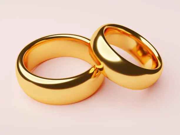 Two wedding gold rings lie next to each other. Love concept. 3d rendering
