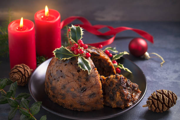 istock Richly spiced Christmas pudding cake with custard and Christmas decorations 1283567815