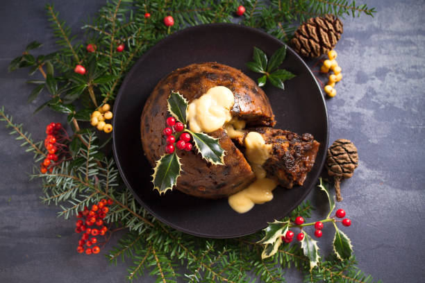 istock Richly spiced Christmas pudding cake with custard and Christmas decorations 1283567830