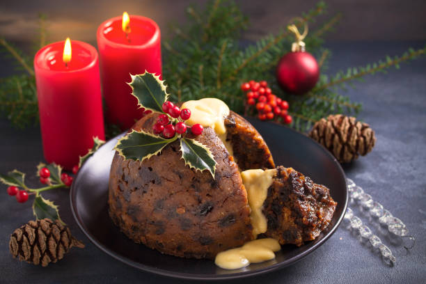istock Richly spiced Christmas pudding cake with custard and Christmas decorations 1283567856