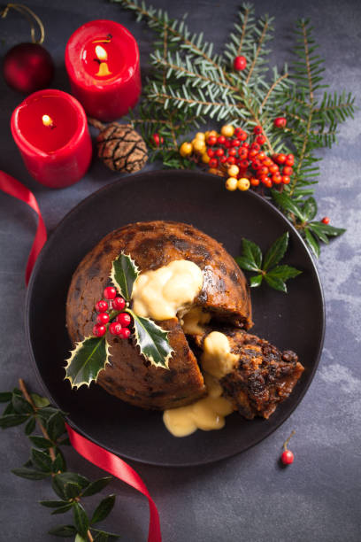 istock Richly spiced Christmas pudding cake with custard and Christmas decorations 1283567864