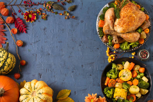 istock Roast chicken or turkey with vegetables and pumpkins. Autumn decorations on the table. Thanksgiving food background 1283567877