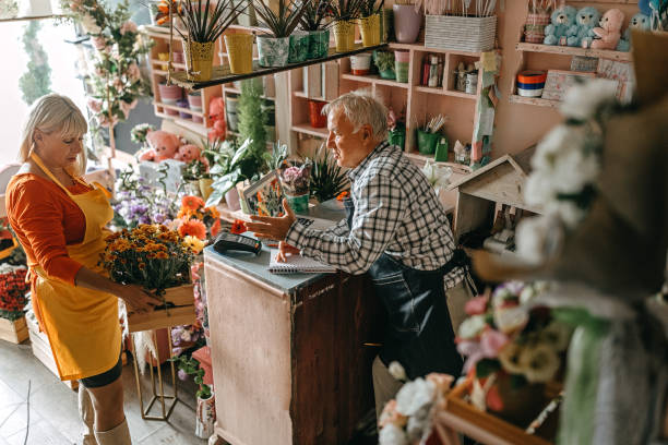 istock Couple Arranging fresh flowers at shop 1283568107