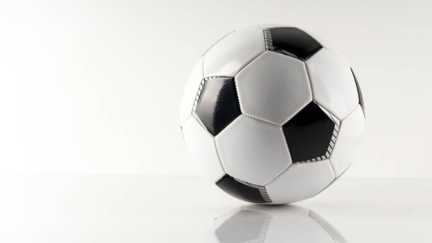 istock Classic soccer ball, typical black and white pattern, isolated on white background. 1283570539