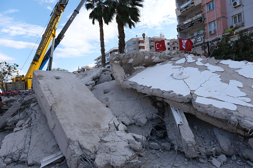 Izmir, Turkey 11/01/2020: Emergency services personnel search a collapsed building for survivors after a powerful earthquake struck on October 30, 2020 in Izmir, Turkey. 92 people have been killed and more than 900 were injured after an earthquake struck the Aegean Sea off the coast of Turkey's Izmir Province. More than twenty buildings were destroyed in Izmir, Turkey's third largest city
