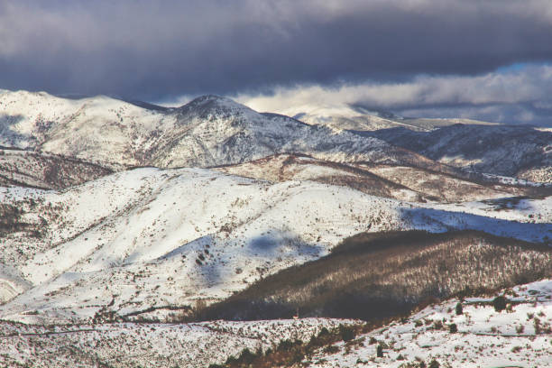 istock Snowy mountains in winter with fog 1283573221