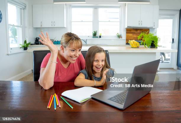 Mother Helping Child Daughter Studying At Home In Selfisolation Or Quarantine Education Home Schooling Remote Learning And School Closures Due To Coronavirus Second Wave Concept Stock Photo - Download Image Now