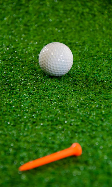 istock Golf ball and  tee on the green 1283574709