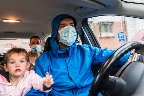 Family traveling in a car during Coronavirus crisis Family traveling in a car during Coronavirus crisis urgency mother working father stock pictures, royalty-free photos & images