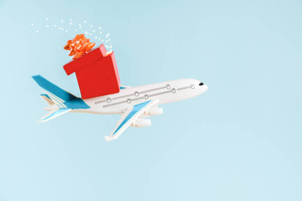istock Airplane flying in the sky with christmas magic gift with copy space. 1283574910