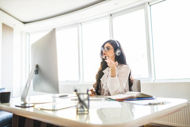 istock Female smart professor wearing headset and holding online class for e-learning school kids and students 1283575541