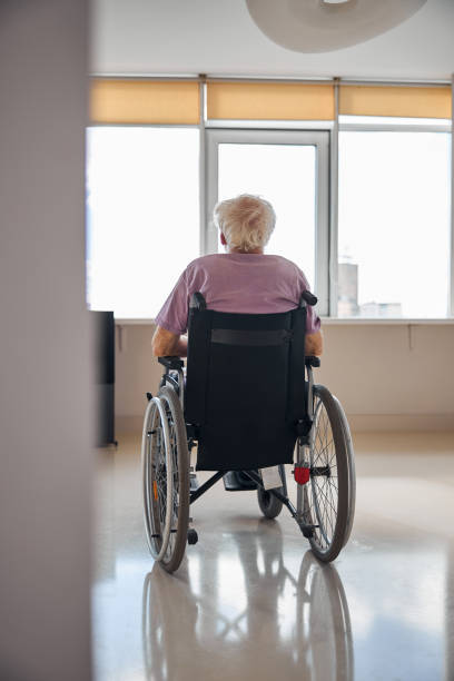 istock Disabled Caucasian man looking through the window 1283575905