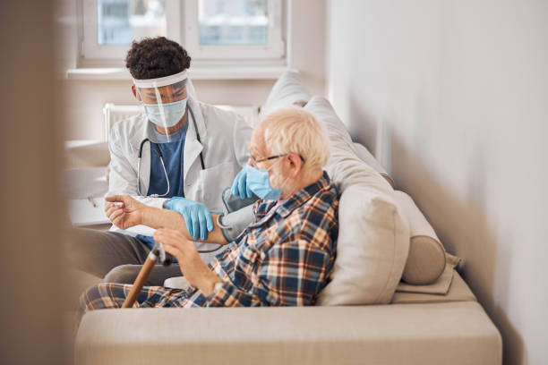 istock Geriatrician wrapping the pressure cuff around the patient upper arm 1283575930