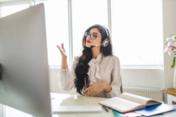istock Smart female professor holding online class for e-learning school kids and students 1283578991