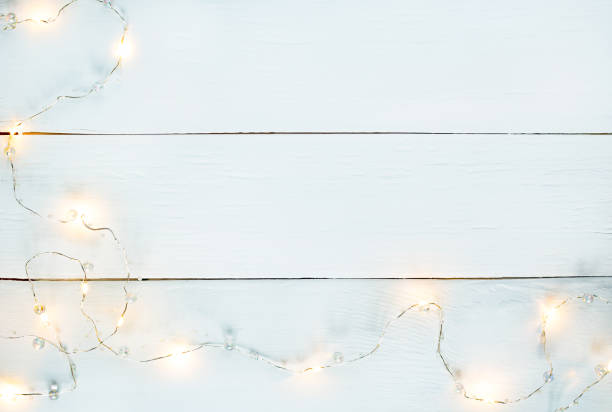 istock white wood horizontal texture background with yellow garland and Copy space 1283579949