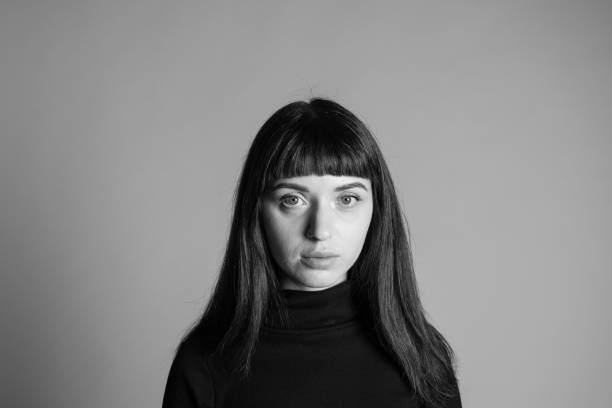 istock Studio portrait of a young woman against plain grey background 1283580275