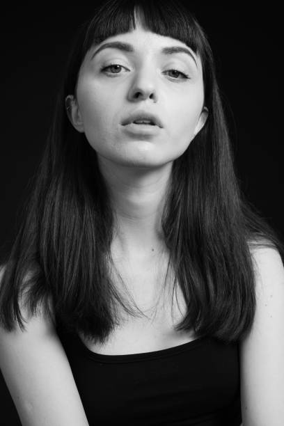 istock Studio portrait of a young woman against plain black background 1283580276