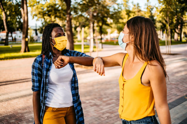 istock Two friends greeting with elbow bump 1283580313