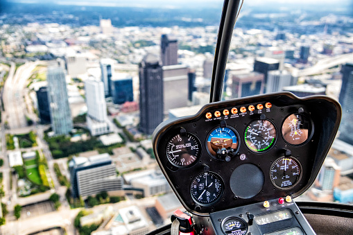 The control panel in the cockpit of a helicopter while flying over the city of Dallas, Texas during