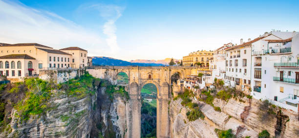 Puente Nuevo bridge and wide panorama of Ronda Puente Nuevo bridge and wide panorama of Ronda town, Spain ravine photos stock pictures, royalty-free photos & images