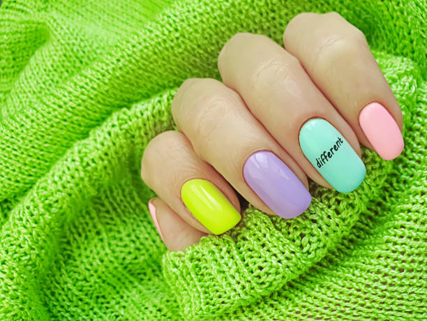 istock female hand beautiful colored manicure sweater 1283585041