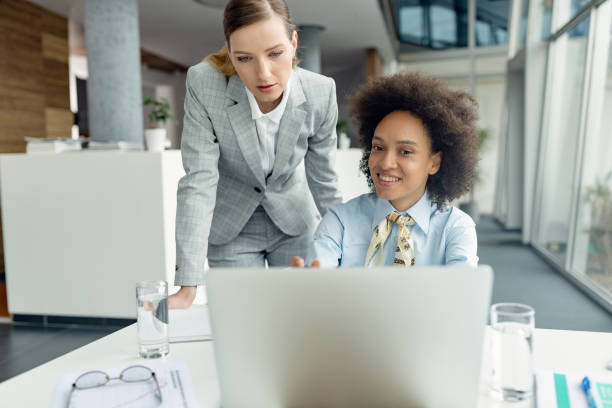 istock Two businesswomen cooperating while working on laptop in the office. 1283586016